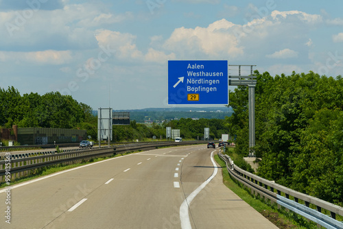 Traveling along the scenic highway towards Aalen and Nordlingen in sunny weather with expansive greenery lining the road photo