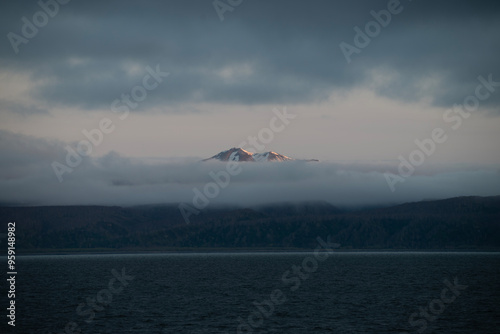 A bay surrounded by snow-capped mountains and dotted with ice formations. The magic of nature in its frozen splendor. A unique combination of ice and sea.Travel in cold weather, fresh air photo