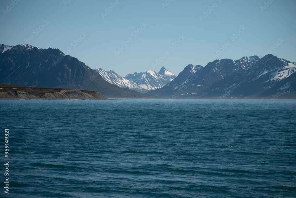 A bay surrounded by snow-capped mountains and dotted with ice formations. The magic of nature in its frozen splendor. A unique combination of ice and sea.Travel in cold weather, fresh air A bay surrounded by snow-capped mountains and dotted with ice formations. The magic of nature in its frozen splendor. A unique combination of ice and sea.Travel in cold weather, fresh air