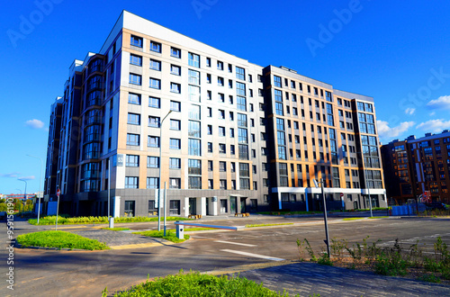 Condominium complex with apartments in green courtyard. Facade of Modern Apartment residential condo building. Private urbanization residential area. Eco-friendly residential building. Eco apartments.