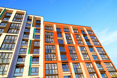 Facade building on blue sky. Modern building, houses. Colorful buildings with glass windows, balconies. Buildings architecture. Urban Residential building exterior. New Residential condominium.