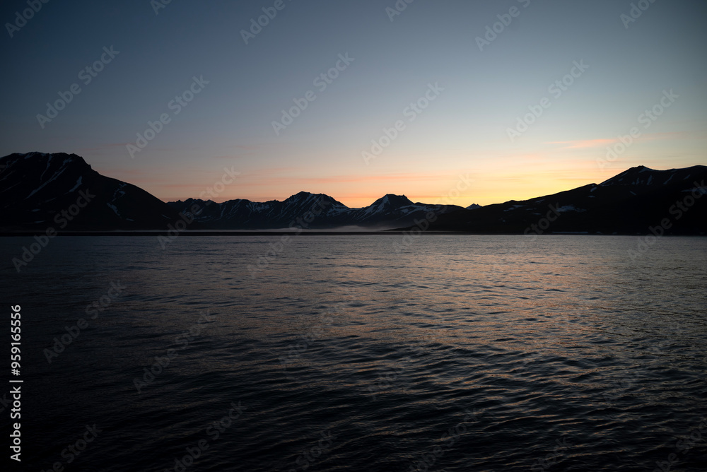 Stunning sunset over mountains and sea on wild natural islands in the northern region of the world, a journey to the cold and fiery sunsets of nature Stunning sunset over mountains and sea on wild natural islands in the northern region of the world, a journey to the cold and fiery sunsets of nature
