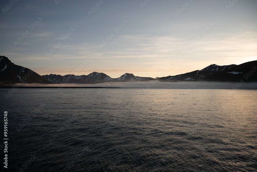 Stunning sunset over mountains and sea on wild natural islands in the northern region of the world, a journey to the cold and fiery sunsets of nature Stunning sunset over mountains and sea on wild natural islands in the northern region of the world, a journey to the cold and fiery sunsets of nature