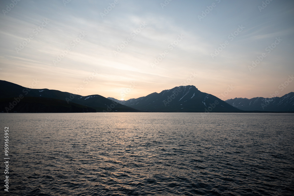Stunning sunset over mountains and sea on wild natural islands in the northern region of the world, a journey to the cold and fiery sunsets of nature Stunning sunset over mountains and sea on wild natural islands in the northern region of the world, a journey to the cold and fiery sunsets of nature