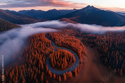 Aerial View of a Serpentine Road Through Autumn Forests and Mountains