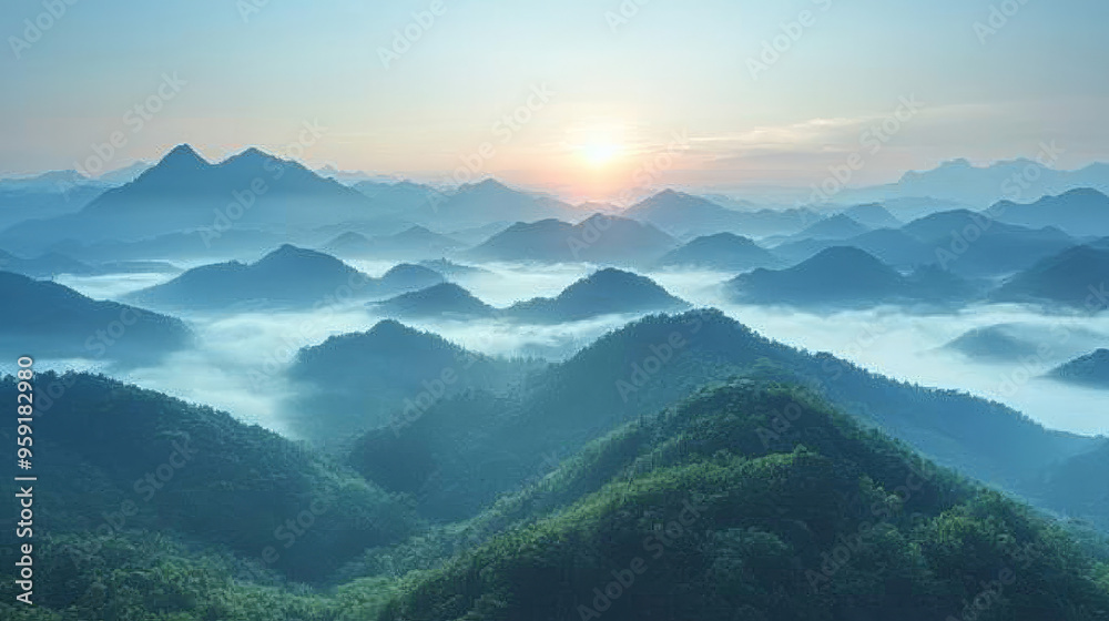 Naklejka premium A stunning sunrise over a mountain range, with soft blue hues and fluffy clouds.