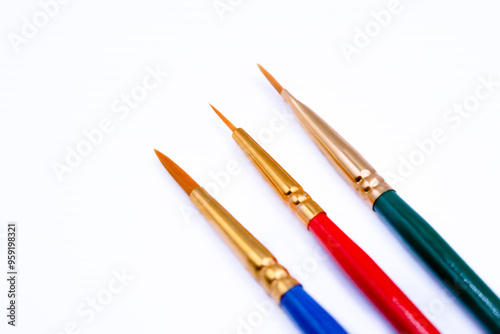 Three brushes on a white background close up