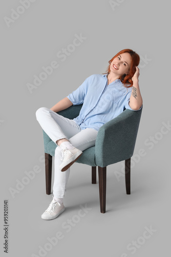 Young woman sitting in soft...