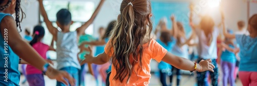 A group of children are dancing and playing in a gym