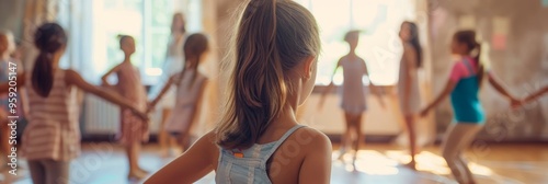 A group of young girls are dancing in a circle