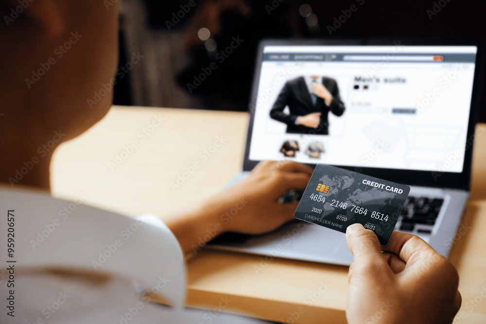 Young man use credit card for shopping payment online on laptop computer application or website. E-commerce and online shopping concept. uds Young man use credit card for shopping payment online on laptop computer application or website. E-commerce and online shopping concept. uds