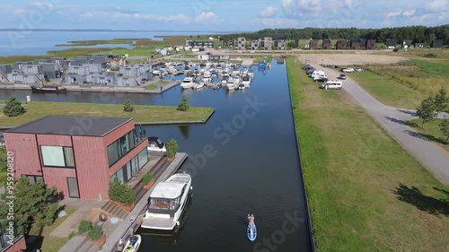 Svencele Village on the Bank of the Curonian Lagoon, Lithuania Water Sport Recreation Area, Kitesurfing, Windsurfing, Kayak, Wakeboarding Aerial Shot. Svencele Dune New Development Residential Buildin photo