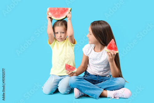 Little girls with slices of...