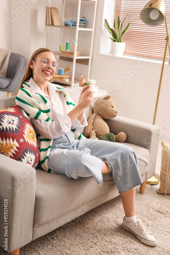 Young woman knitting with n...