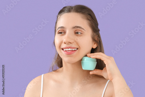 Young woman with jar of fac...