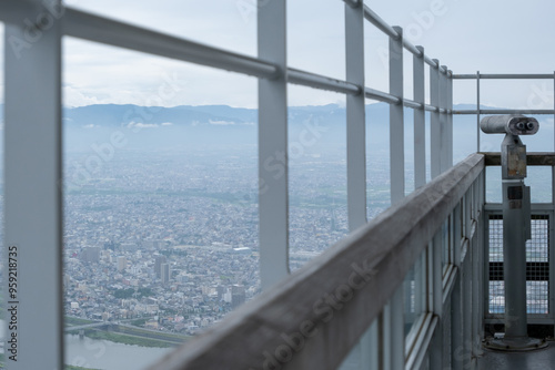 The observatory platform at Gifu Castle on Mount Kinka with a tourist coin-operated telescope frames a breathtaking panoramic view of the Japanese city below.  photo