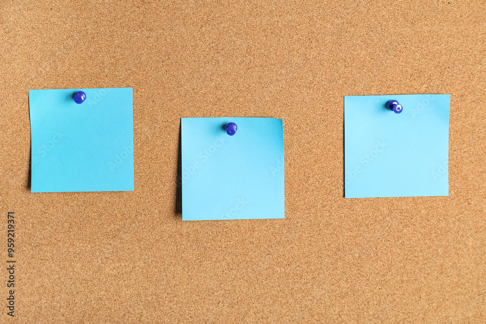 Blank sticky notes on cork board as background Blank sticky notes on cork board as background