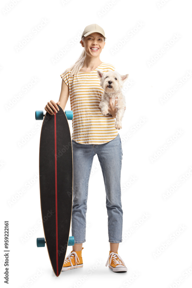Young female posing with a longboard and dog in her hands Young female posing with a longboard and dog in her hands