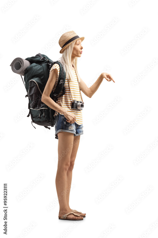 Full length shot of a young female tourist with a backpack pointing Full length shot of a young female tourist with a backpack pointing