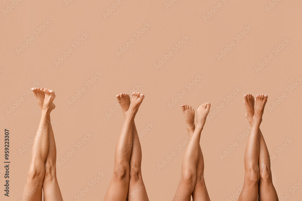 Legs of beautiful different body positive women on beige background, closeup