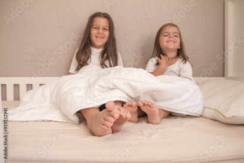 Tableau sur toile little girls playing in their room and tickling and hugging each other