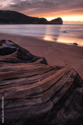 stunning unique rocks at Maitland Bay beach during sunrise on central coast of nsw australia photo