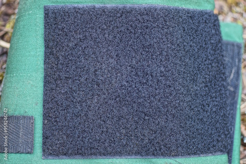 Bild auf Leinwand large black square velcro on green fabric of blood pressure monitor tonometer