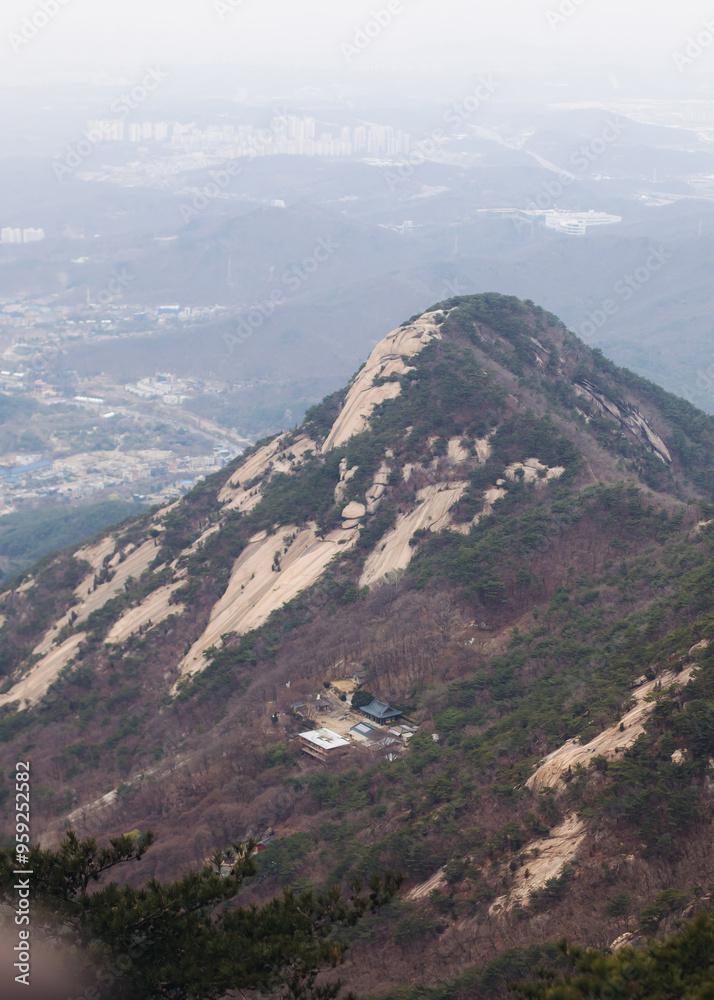 Obraz premium Bukhansan National Park, Seoul, Gyeonggi-do, South Korea, spring landscape view during hike to Baegundae summit peak, process of trekking and climbing to Bukhan mountain, travel and hiking in Korea