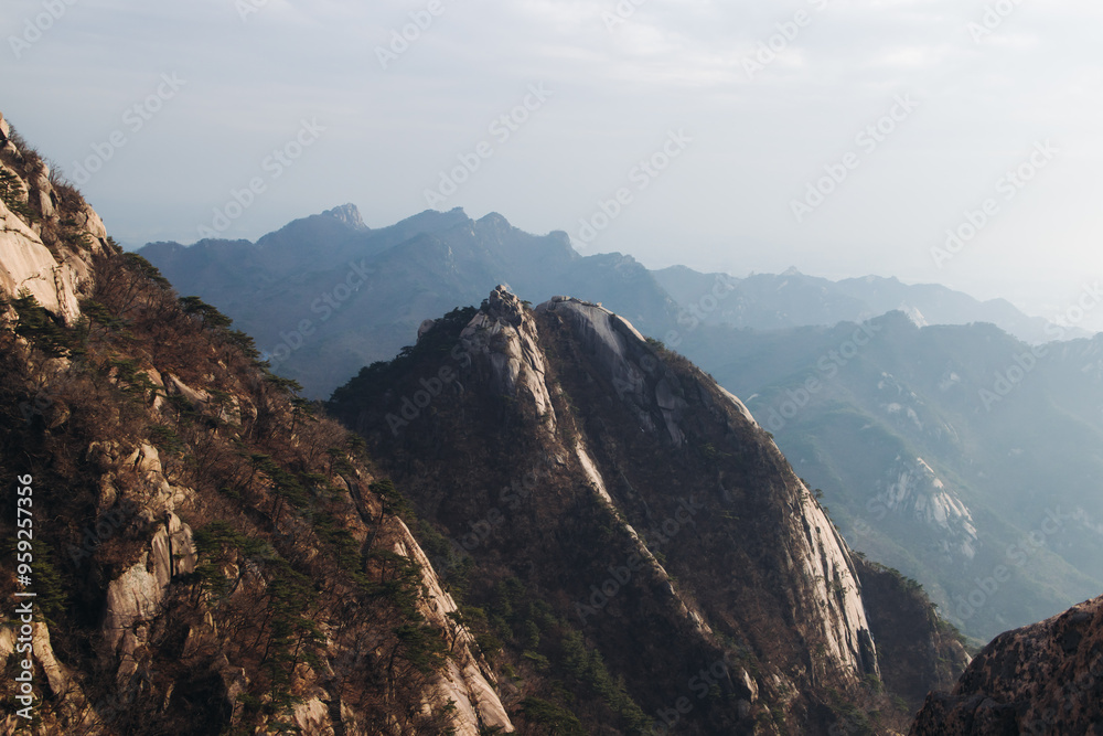 Fototapeta premium Bukhansan National Park, Seoul, Gyeonggi-do, South Korea, spring landscape view during hike to Baegundae summit peak, process of trekking and climbing to Bukhan mountain, travel and hiking in Korea