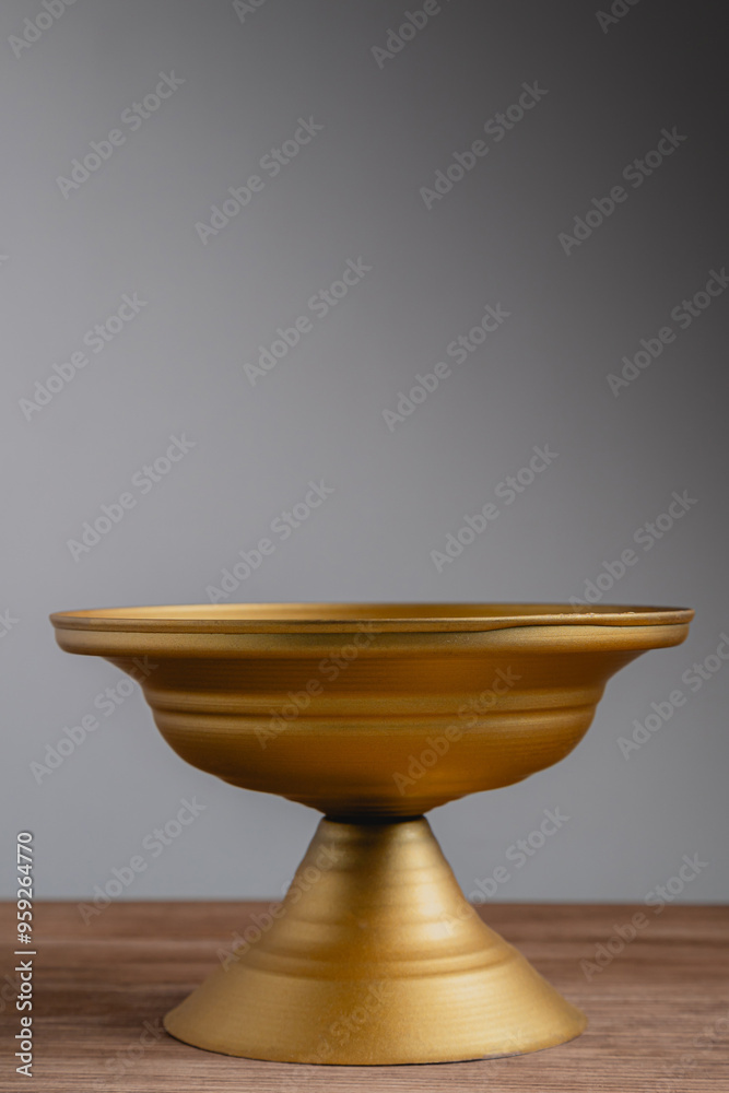 Empty golden pedestal vase with space for text and copy Empty golden pedestal vase with space for text and copy