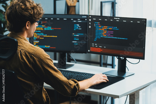Tableau sur toile IT developer working online software development on pc monitors at modern home office on coding application screens, creating updated latest program firmware information version concept