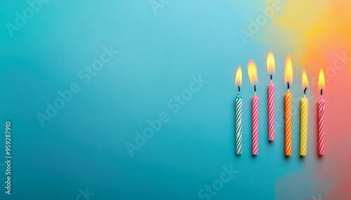 Colorful birthday candles with flames on a vibrant background, perfect for celebrating special moments and joyful occasions. photo