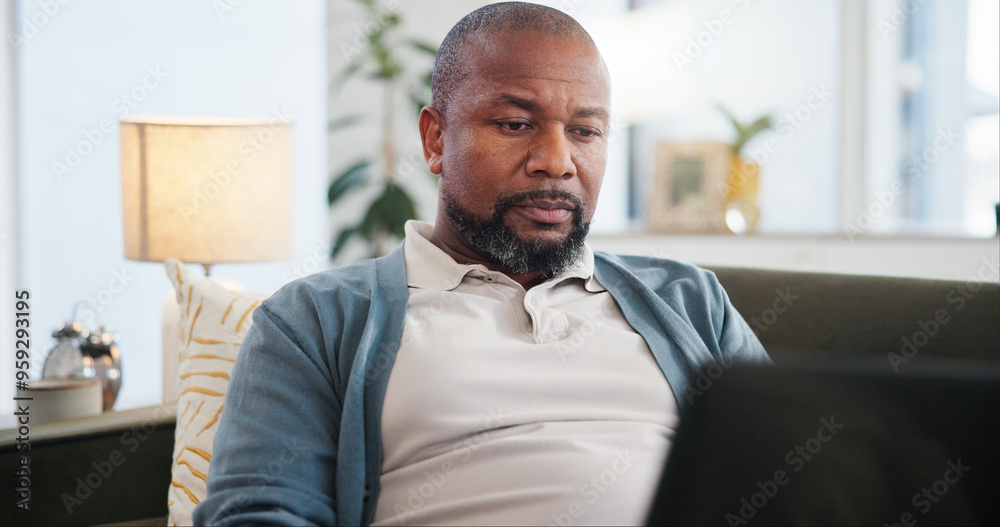 Laptop, reading and black man on sofa in home for research on holiday planning with flight ticket. Computer, living room and African person browsing online for review for hotel booking with travel. Laptop, reading and black man on sofa in home for research on holiday planning with flight ticket. Computer, living room and African person browsing online for review for hotel booking with travel.