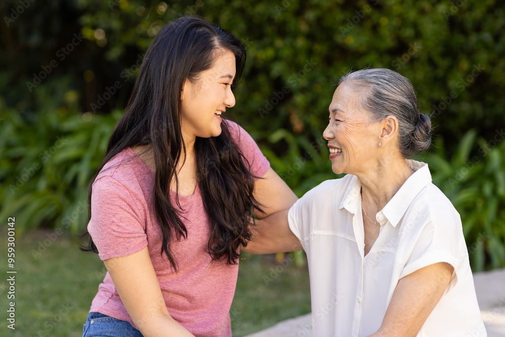 Bonding outdoors, smiling granddaughter enjoying quality time with asian grandmother