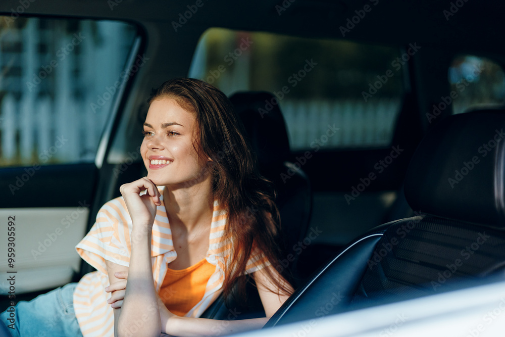 Young woman smiling in a car, casual summer outfit, natural light, cheerful mood, enjoying the moment, relaxed atmosphere, soft background Young woman smiling in a car, casual summer outfit, natural light, cheerful mood, enjoying the moment, relaxed atmosphere, soft background