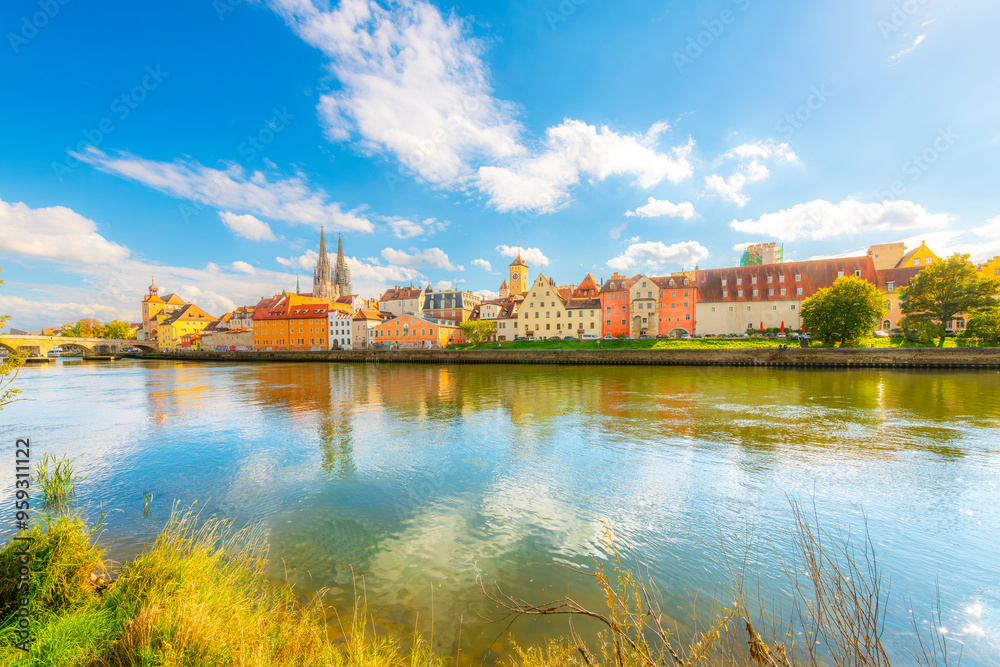 Fototapeta premium The picturesque skyline including the stone bridge over the Danube River, Saint Peter's Church and Regensburg Town Hall in the Bavarian city of Regensburg, Germany. 