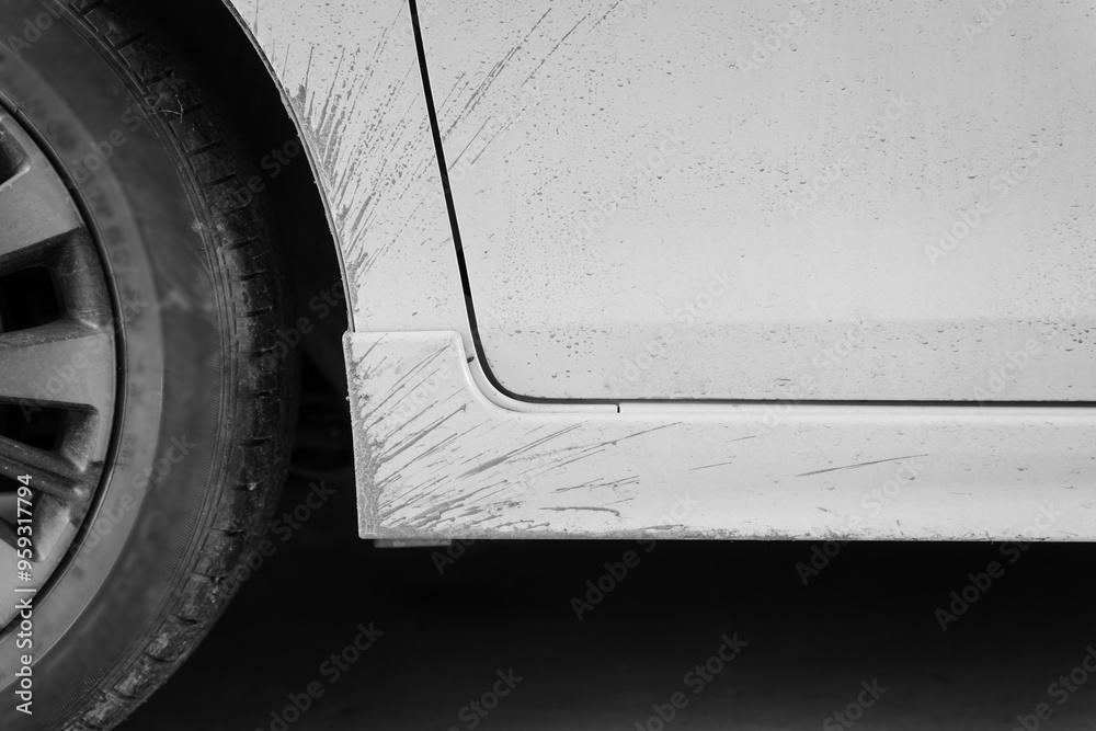 A close-up shot of a muddy sedan captures the rugged exterior, showcasing dirt splattered across the wheels and body, emphasizing its recent journey through challenging off-road terrain. A close-up shot of a muddy sedan captures the rugged exterior, showcasing dirt splattered across the wheels and body, emphasizing its recent journey through challenging off-road terrain.