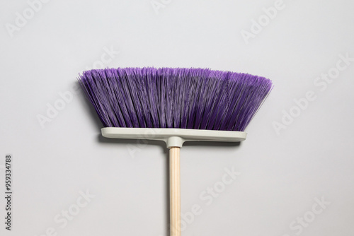 One broom on light grey background, top view. Cleaning tool