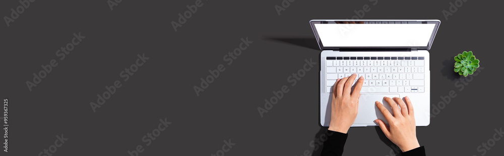 Person using a laptop computer from above Person using a laptop computer from above
