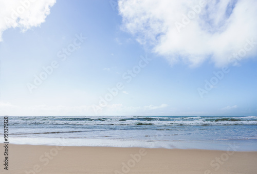 Surf beach straight on view , a peaceful scene of surf waves rolling onto a sandy beach along the shore at Kawana on the Sunshine Coast Queensland Australia on a cloudy winter day. photo