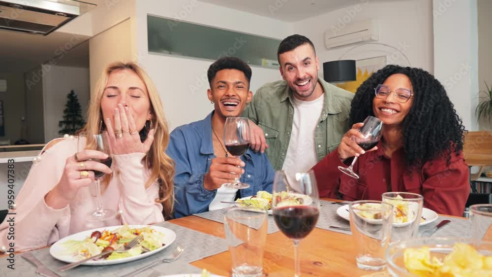 Portrait of a group of multiracial young friends having a lunch and eating together, enjoying a salad. Two multiethnic couples looking at the camera while having a healthy vegetarian dinner at home. Portrait of a group of multiracial young friends having a lunch and eating together, enjoying a salad. Two multiethnic couples looking at the camera while having a healthy vegetarian dinner at home.