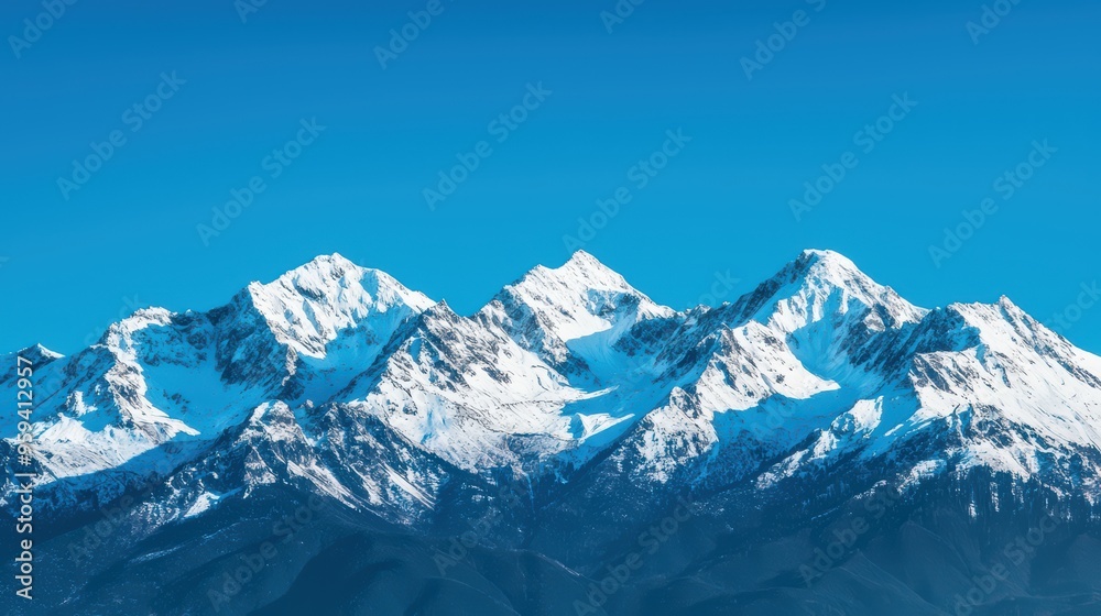 Obraz premium Majestic Snow-Capped Mountain Range Under Clear Blue Sky in Winter
