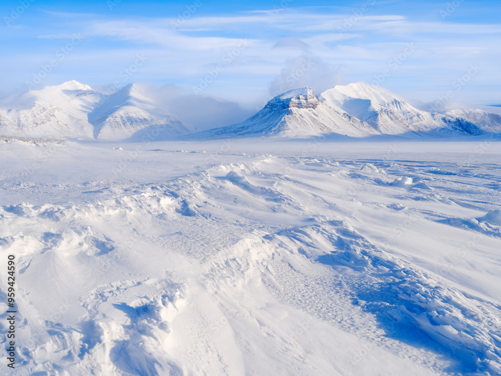 View over frozen Petuniabukta in fjord Billefjorden. Winter landscape on the island Spitsbergen in the Svalbard Archipelago. Scandinavia, Norway.