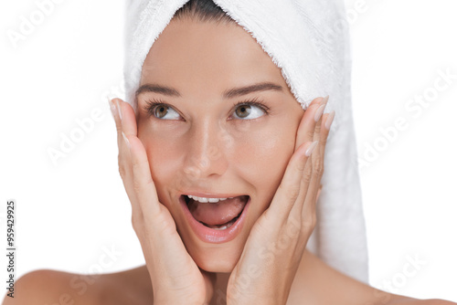 Surprised Woman with Towel Wrapped Head Expressing Excitement During Skincare