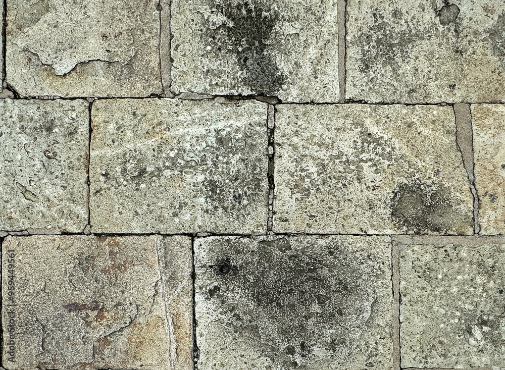Fototapeta premium Dark grey paving stone rectangular blocks made of natural cobbles stone for outdoor pavement floors.