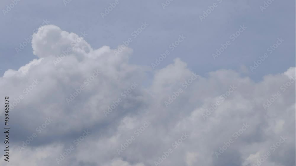 Fluffy rolling clouds time lapse on blue sky. Versatile background, overlay or transition. Fluffy rolling clouds time lapse on blue sky. Versatile background, overlay or transition.
