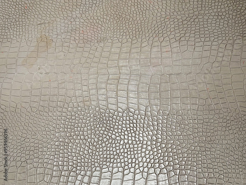 Close up photo of snake scale skin crafted and printed on a genuine leather sheet on table top. photo