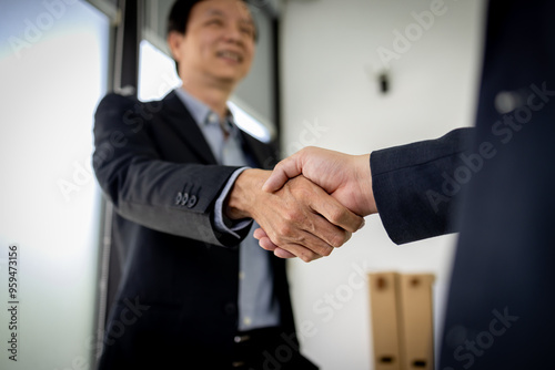 Handshake of two businessmen who enters into the contract to develop a new software to improve business service at a company. 