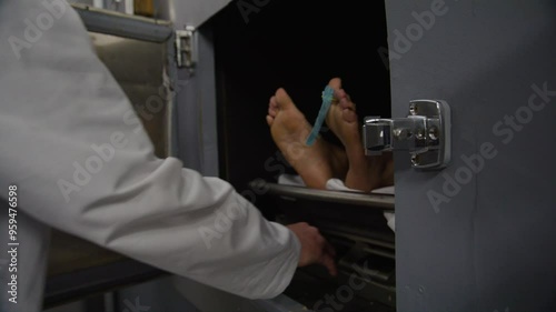 Morgue doctor taking corpse out of cooler
