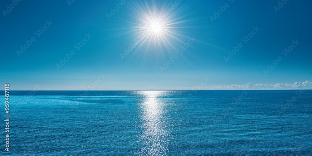 Obraz premium Bright sun shines over calm blue ocean water.